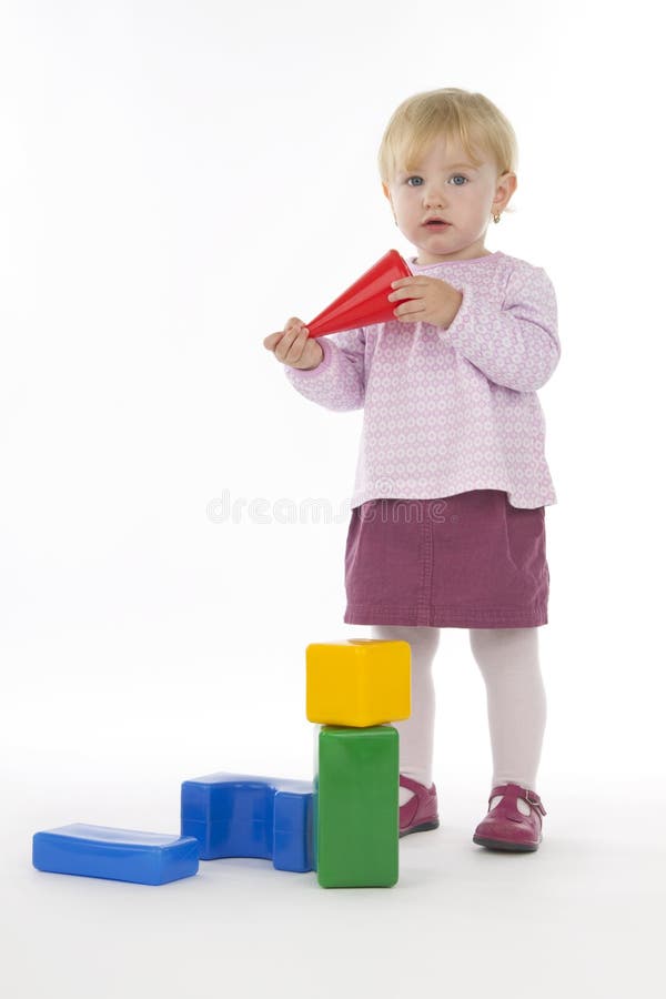 Little girl with plastic cubes.