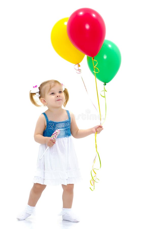 Little girl is playing with a balloon