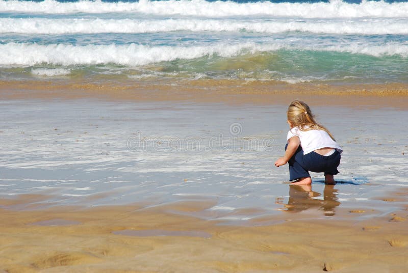 Little girl playing at beach