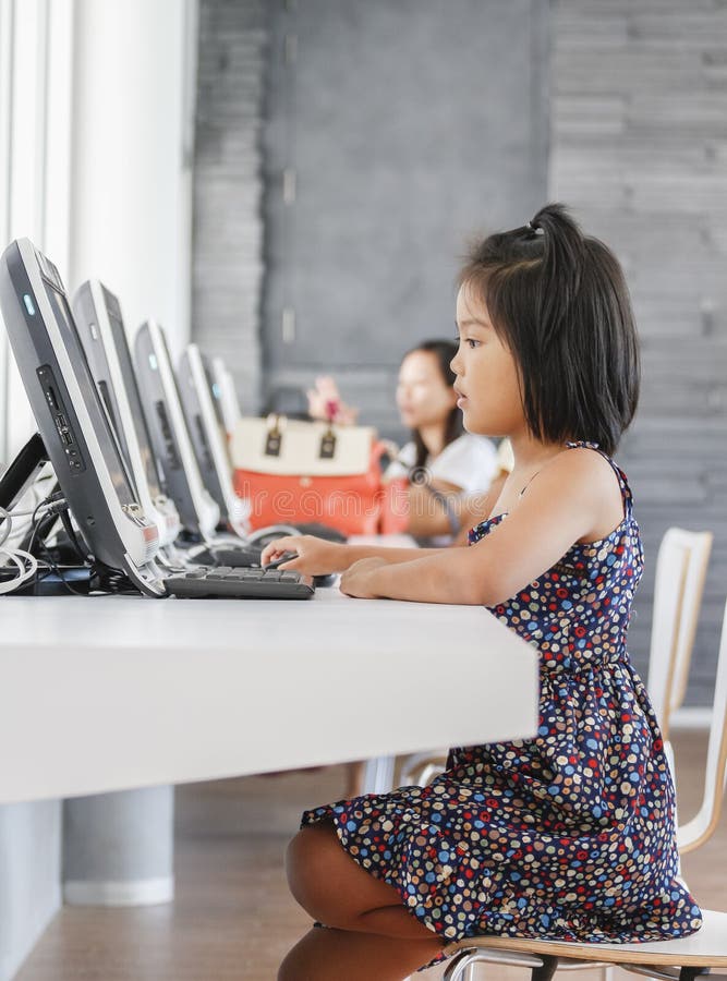 Little girl playing computer