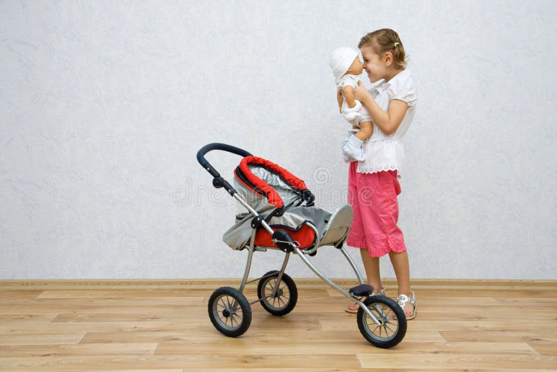 Little girl playing with doll stock images