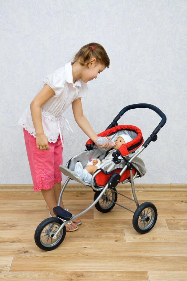 Little girl playing with doll stock photos