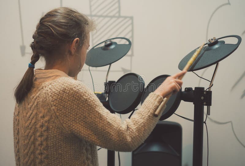 Little girl playing drums. stock photo. Image of back 108216796