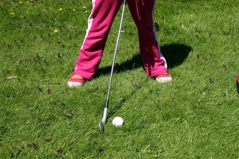 Little girl playing golf