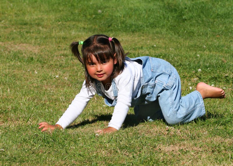 Little Girl Playing on the Grass