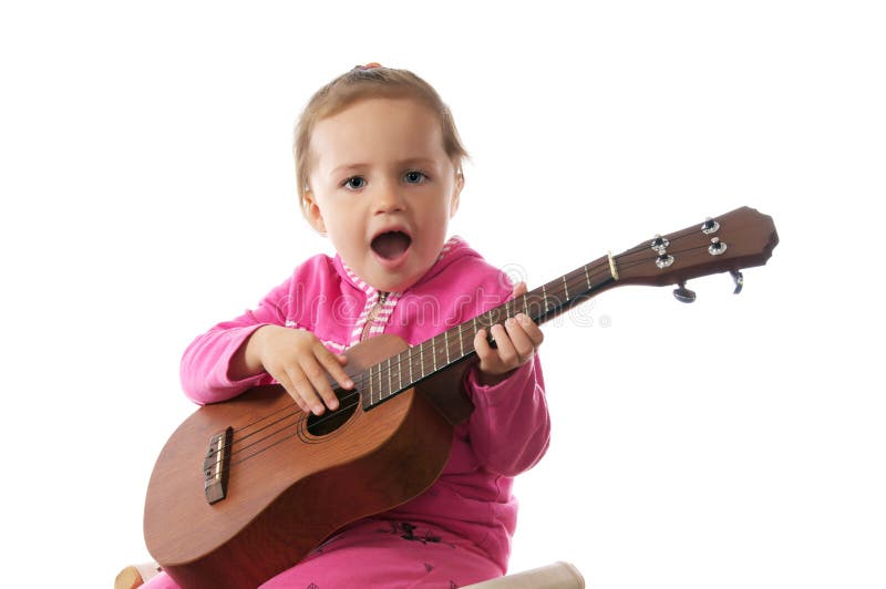 Little girl playing guitar.