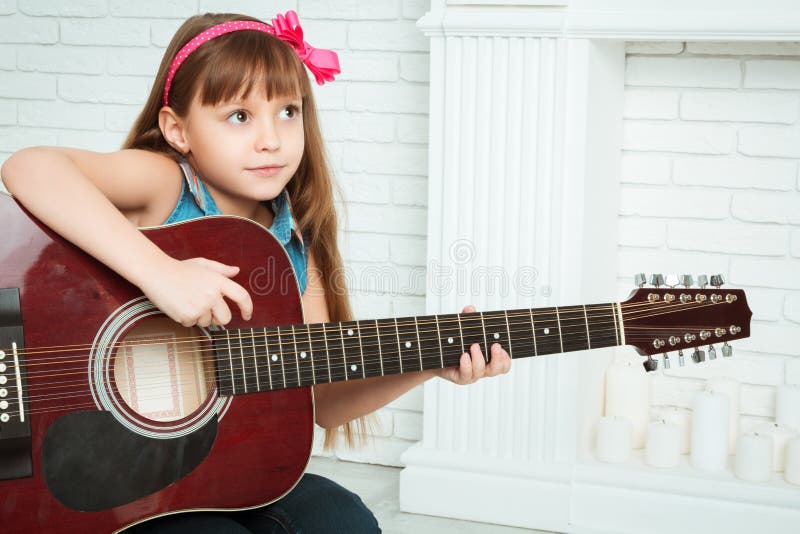 Little girl playing guitar stock image. Image of portrait 71615045
