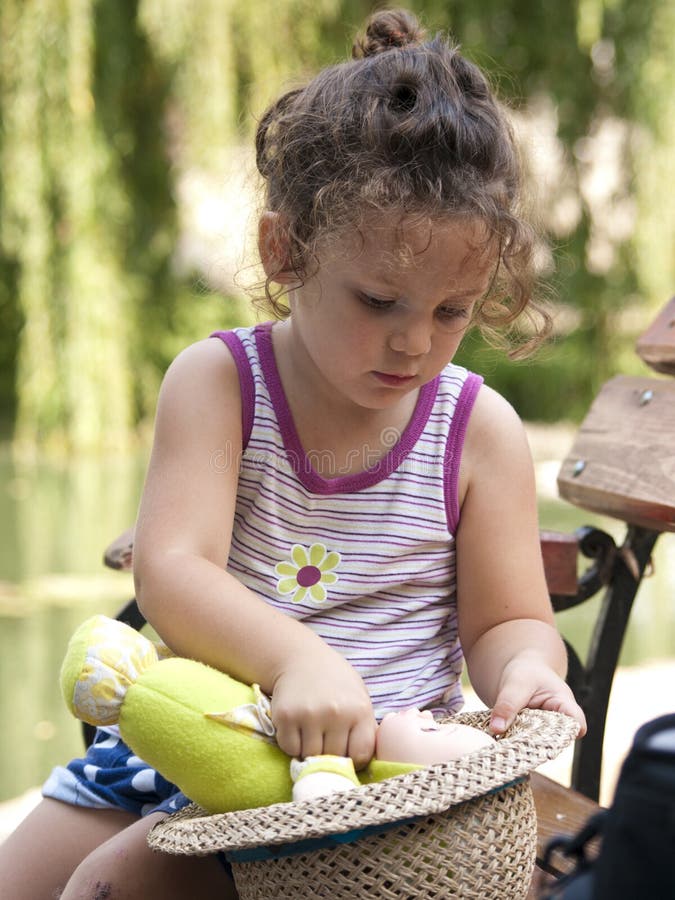 Little girl playing with her doll