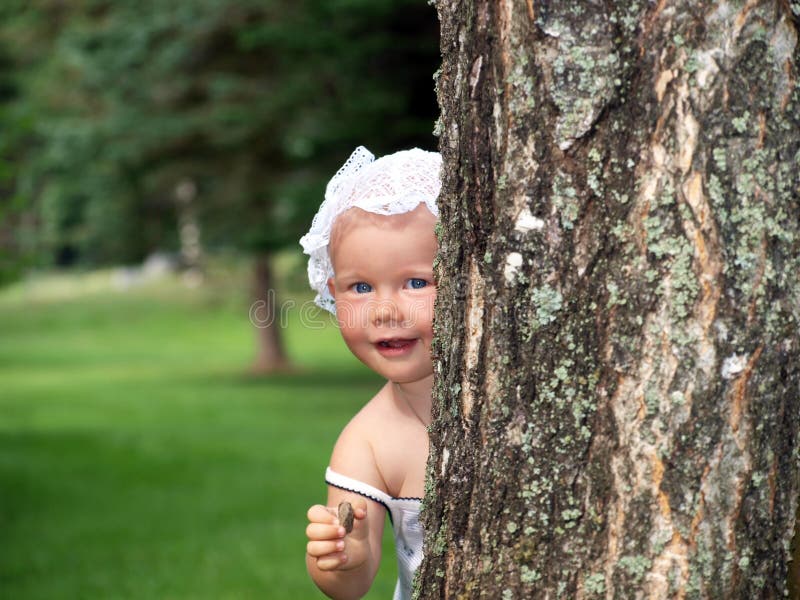 Little child is playing hide-and-seek