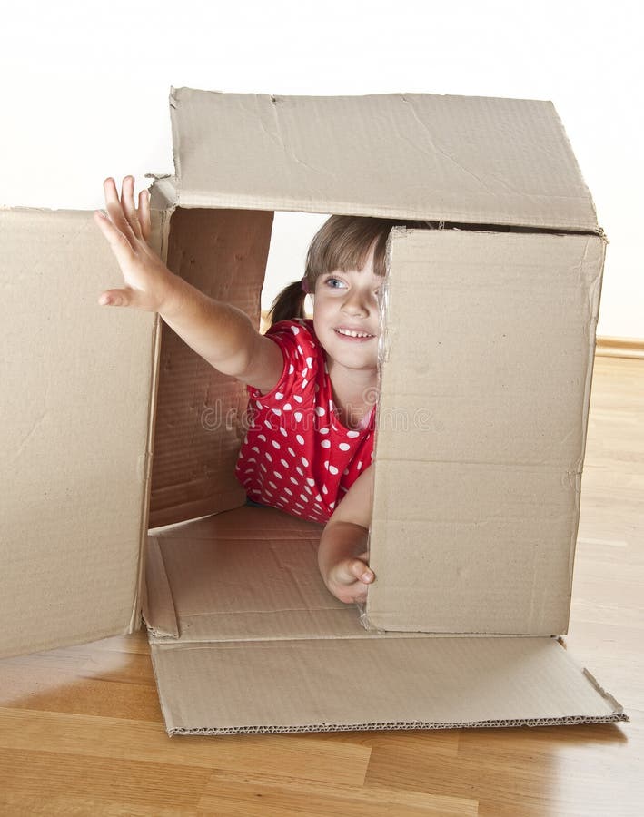 Little girl playing inside box