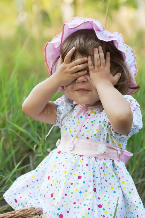 Little girl playing peek-a-boo
