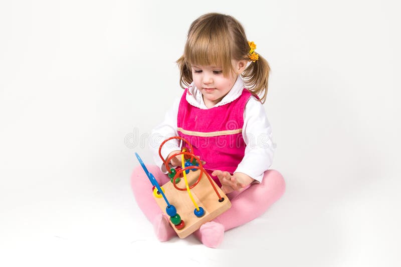 Little girl playing with puzzle toy
