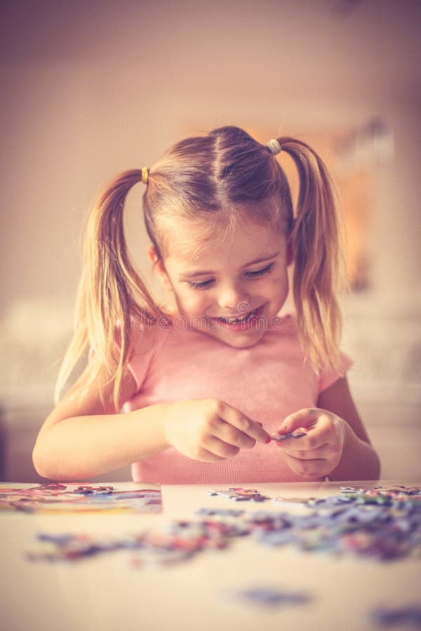 Little Girl Playing with Puzzles. Stock Photo Image of cute