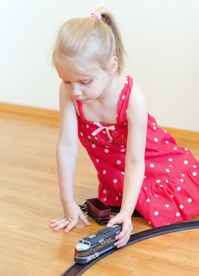 Little girl playing with railway