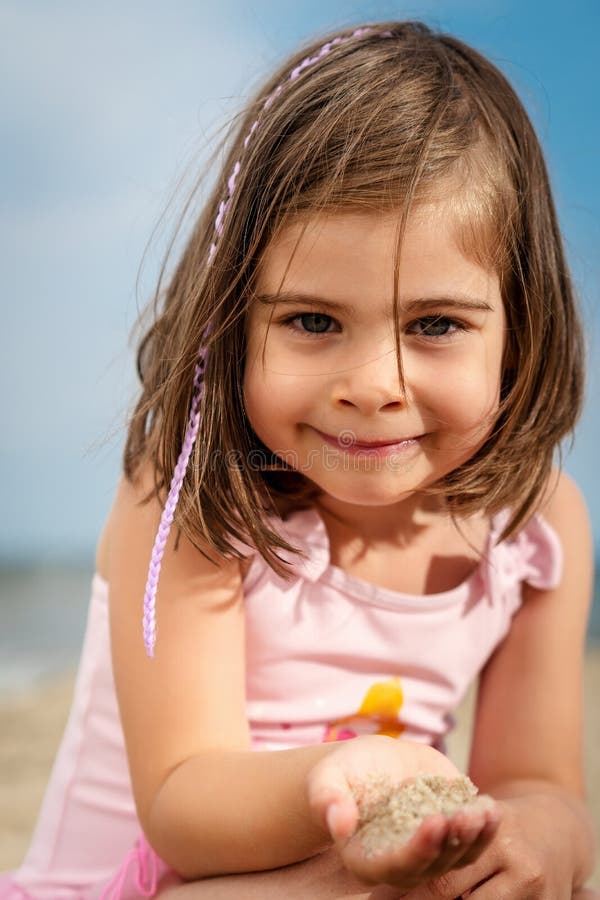 Little Girl is Playing on the Sand at the Beach Stock Image - Image of ...