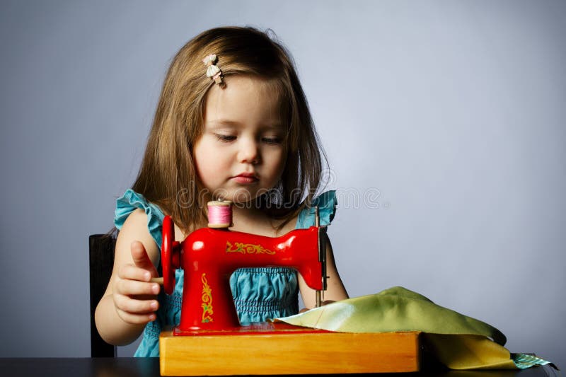 Little Girl is Playing with Sewing Machine Stock Image Image of