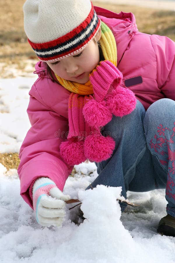 Little girl playing with snow