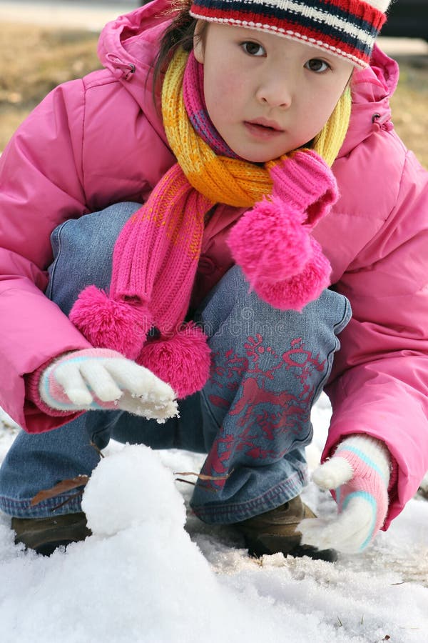 Little girl playing with snow