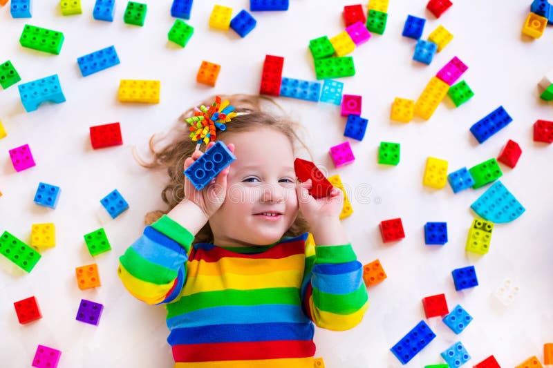 Little girl playing with toy blocks