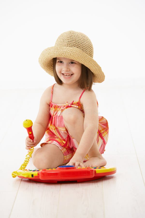 Little girl playing with toy instrument