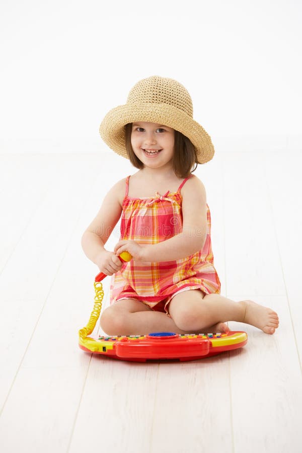 Little girl playing with toy instrument