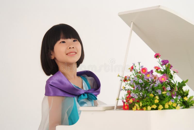Little girl playing toy piano