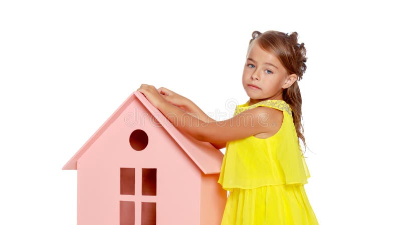 Little girl is playing with wooden houses. royalty free stock photos Little girl is playing with wooden houses. royalty free stock photos