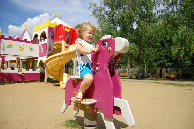 The little girl plays attractions royalty free stock photo