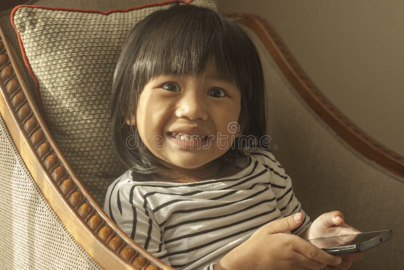 Little Girl Plays with Gadget Smart Phone stock photos