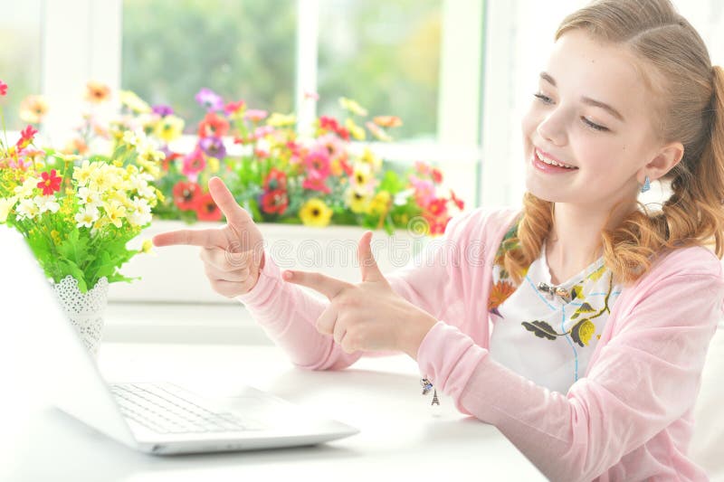 Little girl pointing to laptop