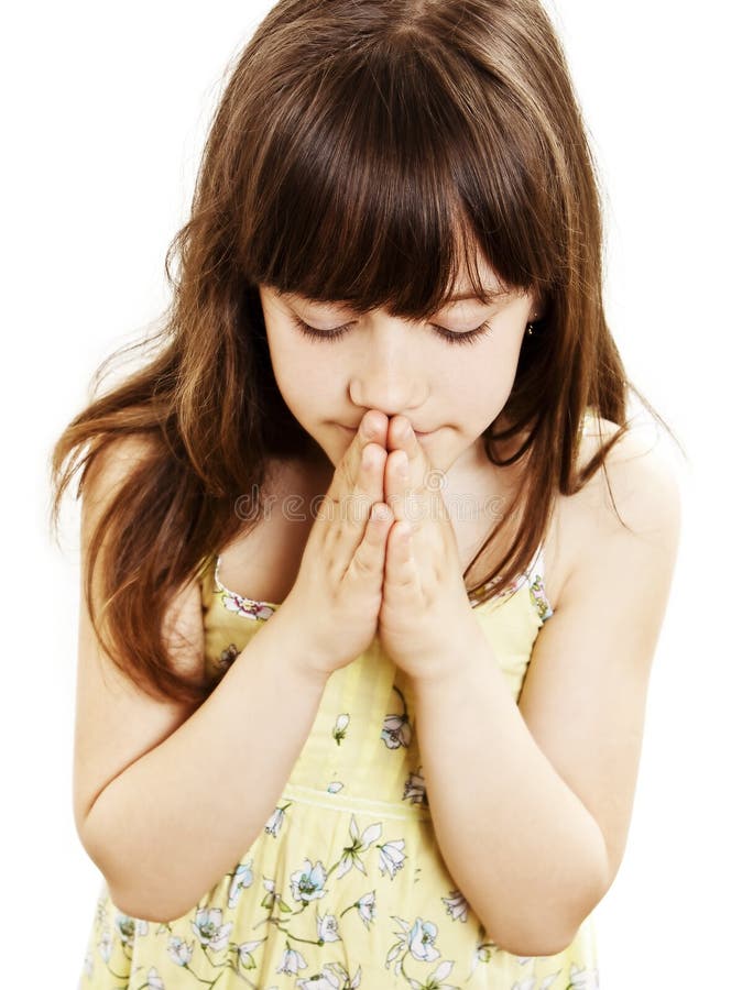 Little girl praying - closeup. Isolated on white