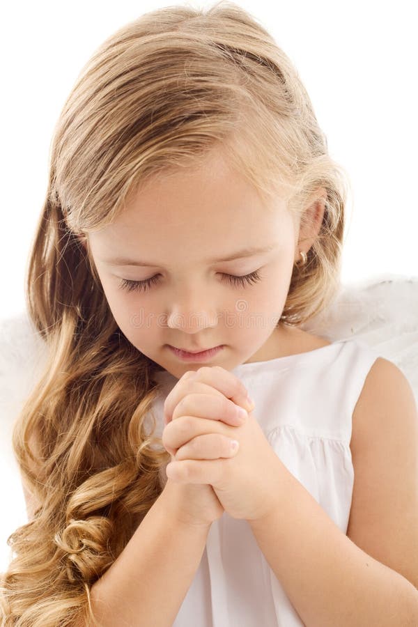 Beautiful little girl praying - closeup, isolated