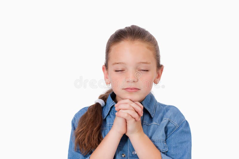 Little girl praying against a white background