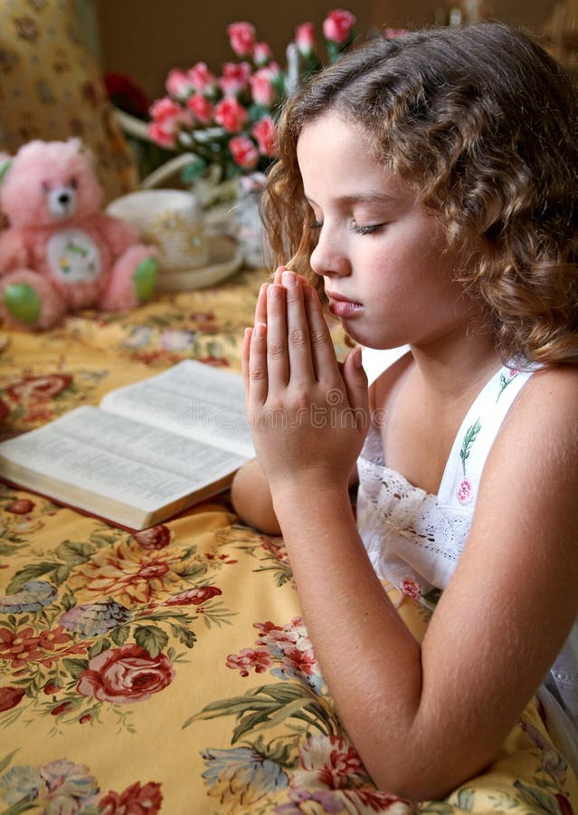 A young girl saying her bedtime prayers. A young girl saying her bedtime prayers.