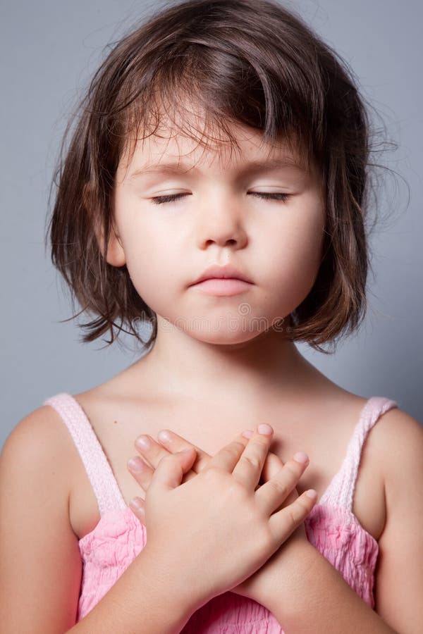 The little girl praying in lotus position