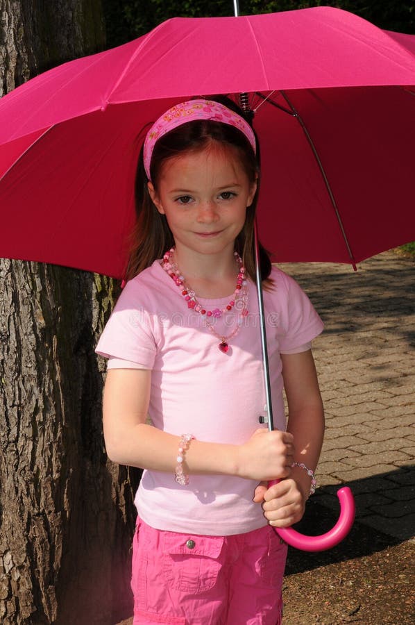 Girl with pink umbrella stock photo. Image of favorite - 24692854