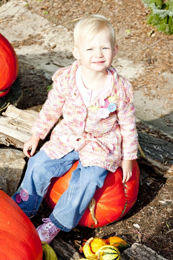 Little girl with pumpkins