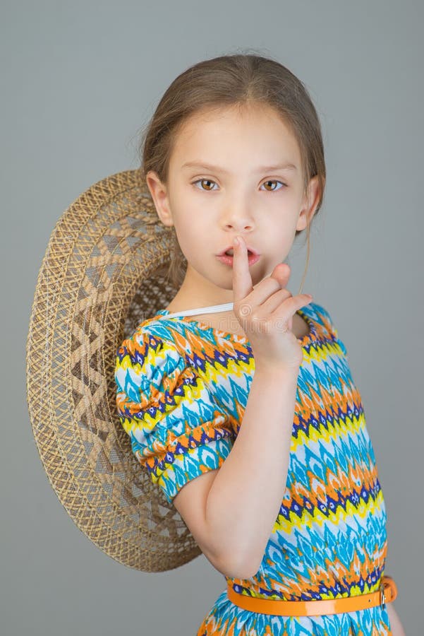 Little girl puts index finger to lips royalty free stock images Little girl puts index finger to lips royalty free stock images