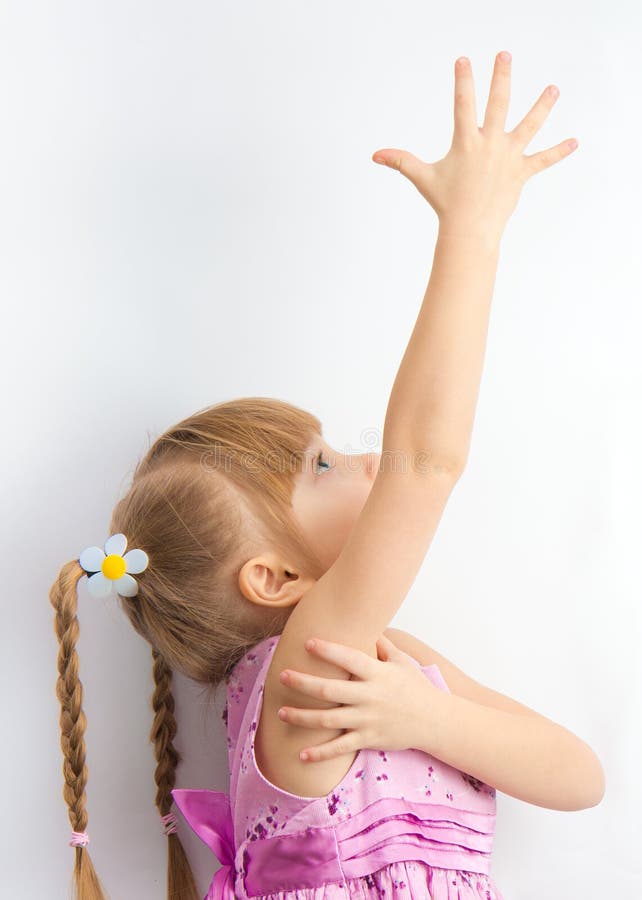 A little girl reaching for something