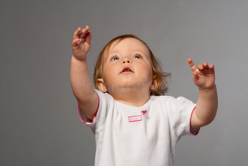 Little girl reachs out her s hands.