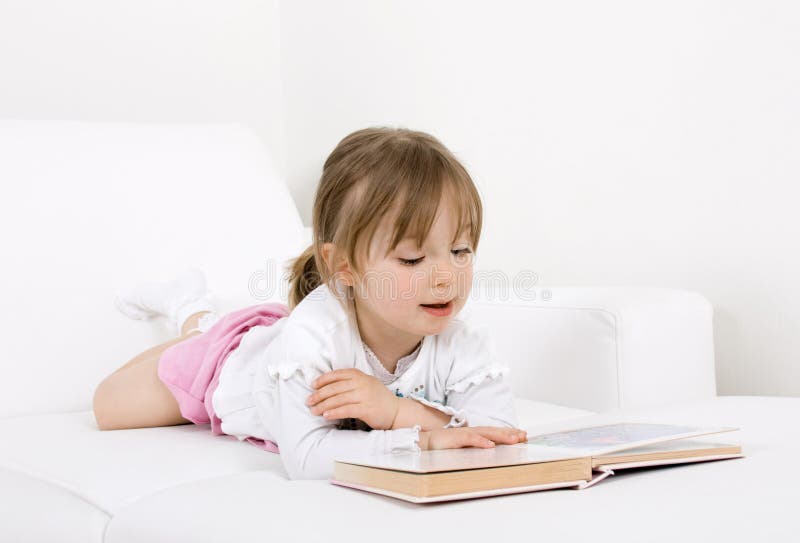 Little girl reading book