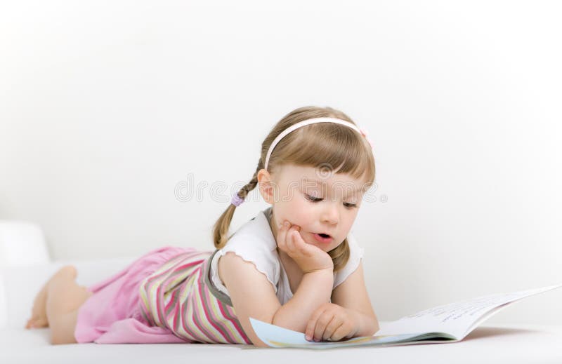 Little girl reading book