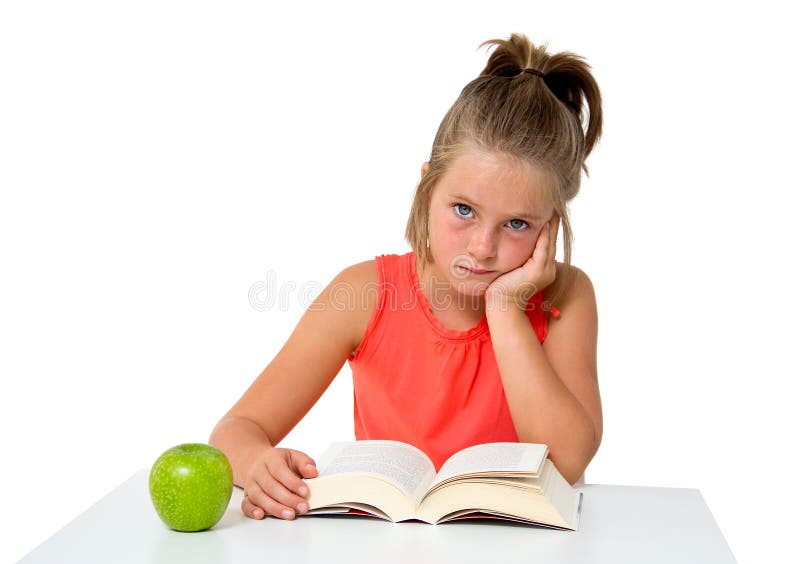 Little girl reading a book with apple isolated on white. Boring kid white stock images, royalty-free photos and pictures