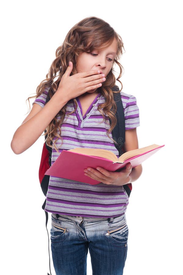 Little girl reading book and yawning. studio shot over white background. Boring kid white stock images, royalty-free photos and pictures