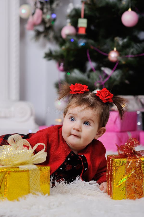 Little Girl in a Red Dress on Background of the Christmas Tree Stock ...