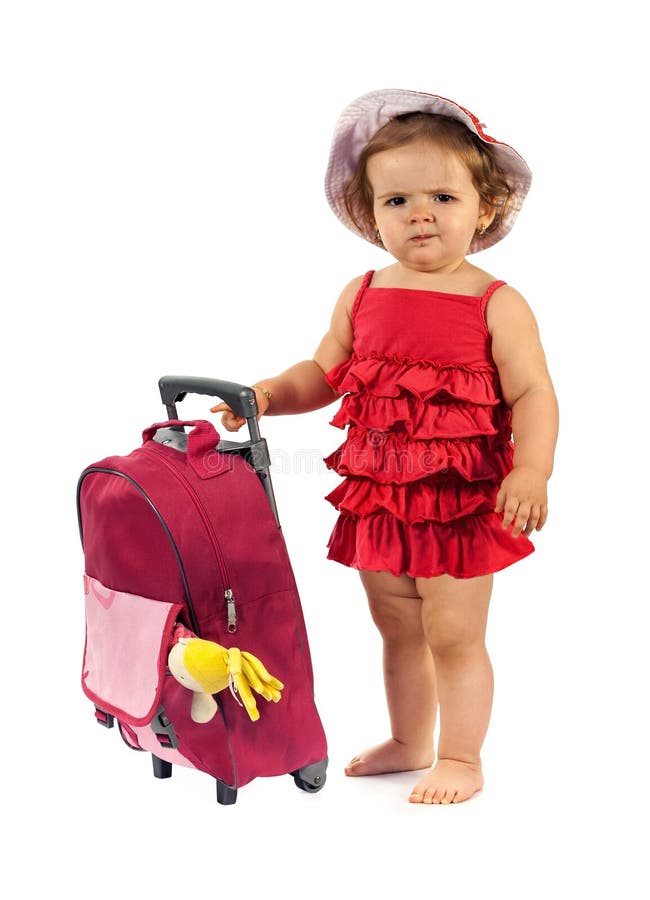 Little girl ready to travel - standing beside a red luggage stock photography Little girl ready to travel - standing beside a red luggage stock photography