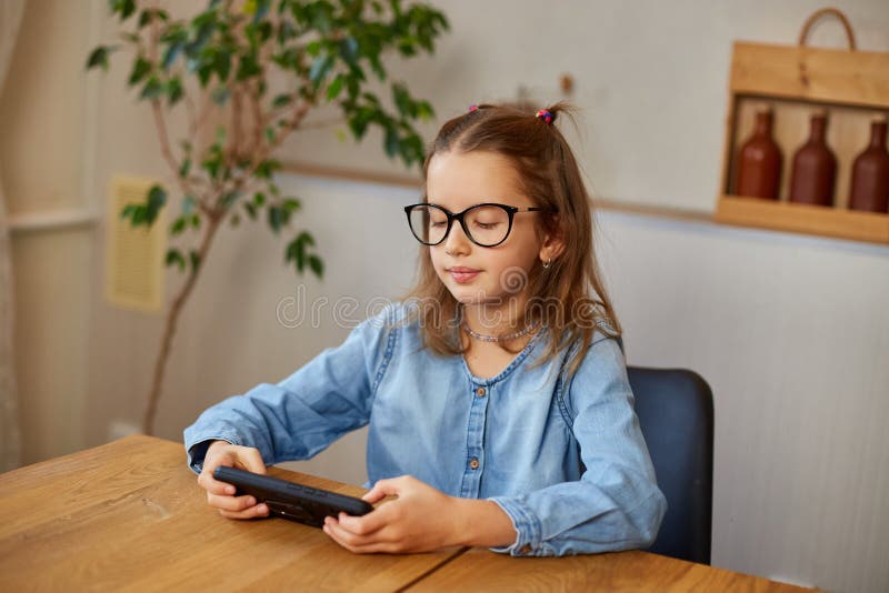 The Little Girl Removes Glasses, Rubbing Eyes Tired from Play Game on ...