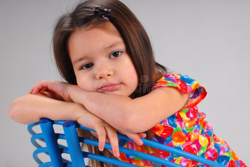 Little girl resting on a chair