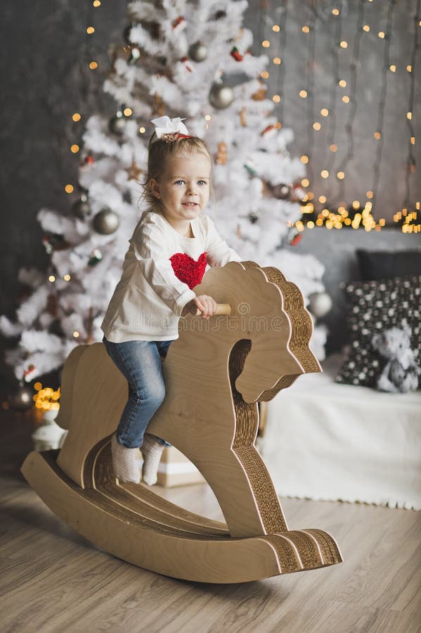 Portrait of a child on paper horse in front of the tree 7076.