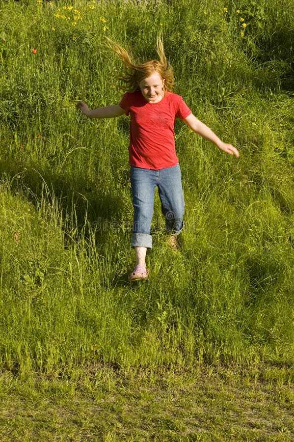 Little girl is running of a hill